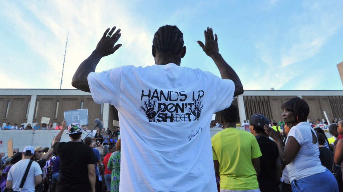 democracynow's tweet photo. Protesters Demand Firing of Cop Who Killed Black Man with Hands in Air #TerenceCrutcher https://t.co/NJ0s1U0UdD https://t.co/JuUgGMZBEz