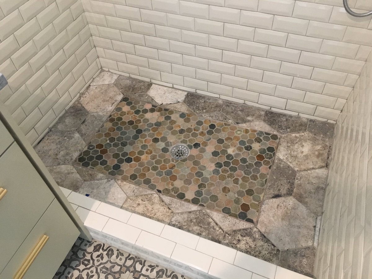 flooredaustin's tweet image. Stone and porcelain shower floor with brass trim