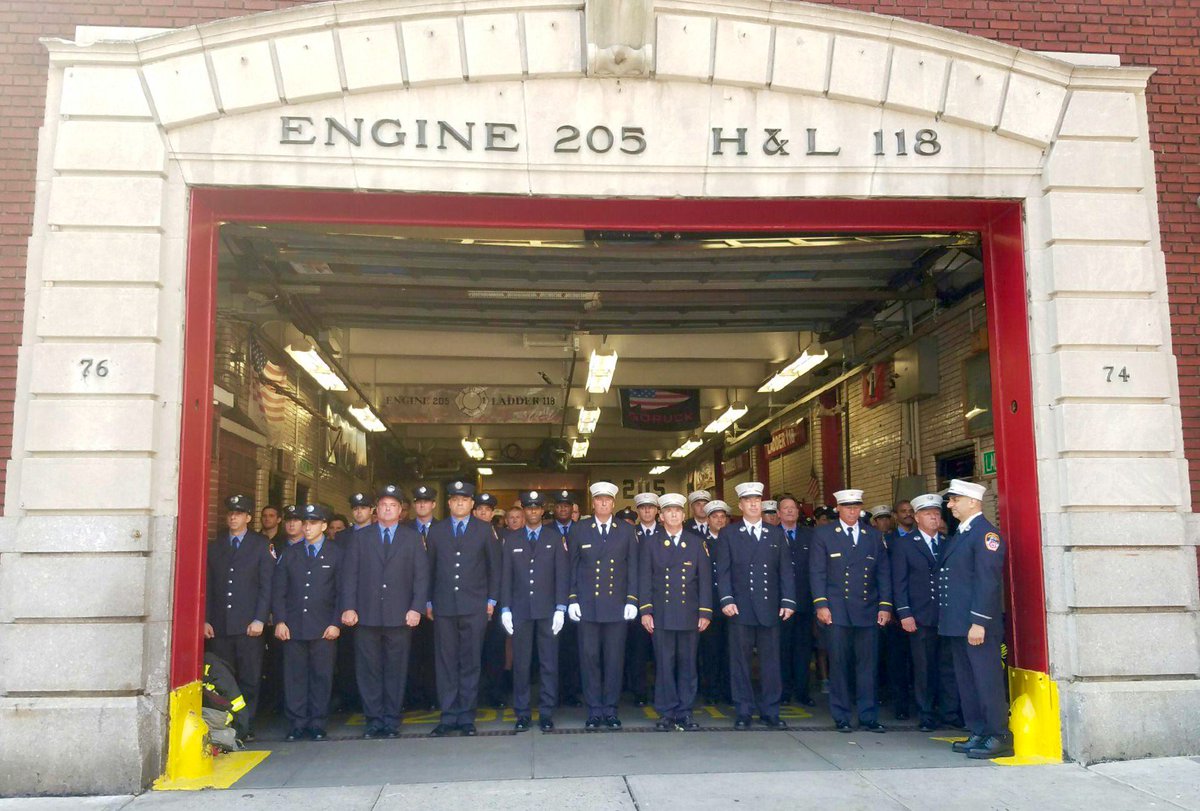 FDNY's tweet photo. #Engine205 #Ladder118 members in #BrooklynHeights observe moment of silence for North Tower collapse #NeverForget https://t.co/5RjiBMS4Ak