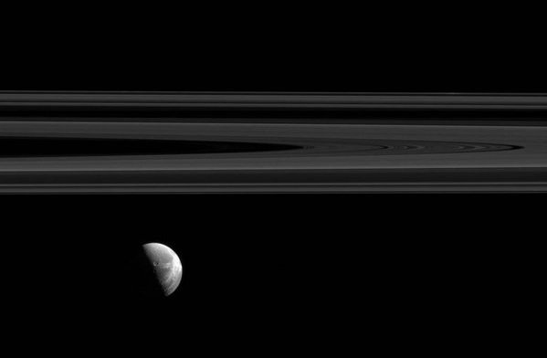 marsrader's tweet photo. Saturn's moon Dione under wisps of the giant rings. https://t.co/dovSsTPVMO