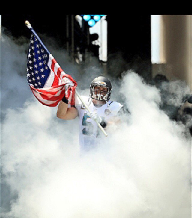 HMJHPrincipal's tweet photo. Hopewell's Paul Posluszny carries the American flag out before the Jaguars game against the Packers.  @HMJHS_Vikings https://t.co/bQEXRCUlCf