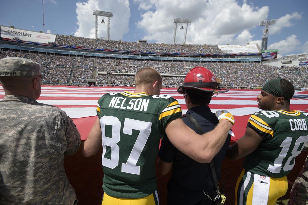 PGPackersNews's tweet photo. Did you see this yesterday? @JordyRNelson and @rcobb18 holding flag alongside firefighter, military https://t.co/Z35rVIzM7A