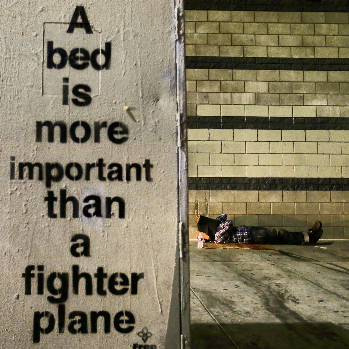 alschaben's tweet photo. A homeless man sleeps on a sidewalk near a sign on 4th St., along Skid Row, downtown Los Angeles https://t.co/cpEPwqNOFa