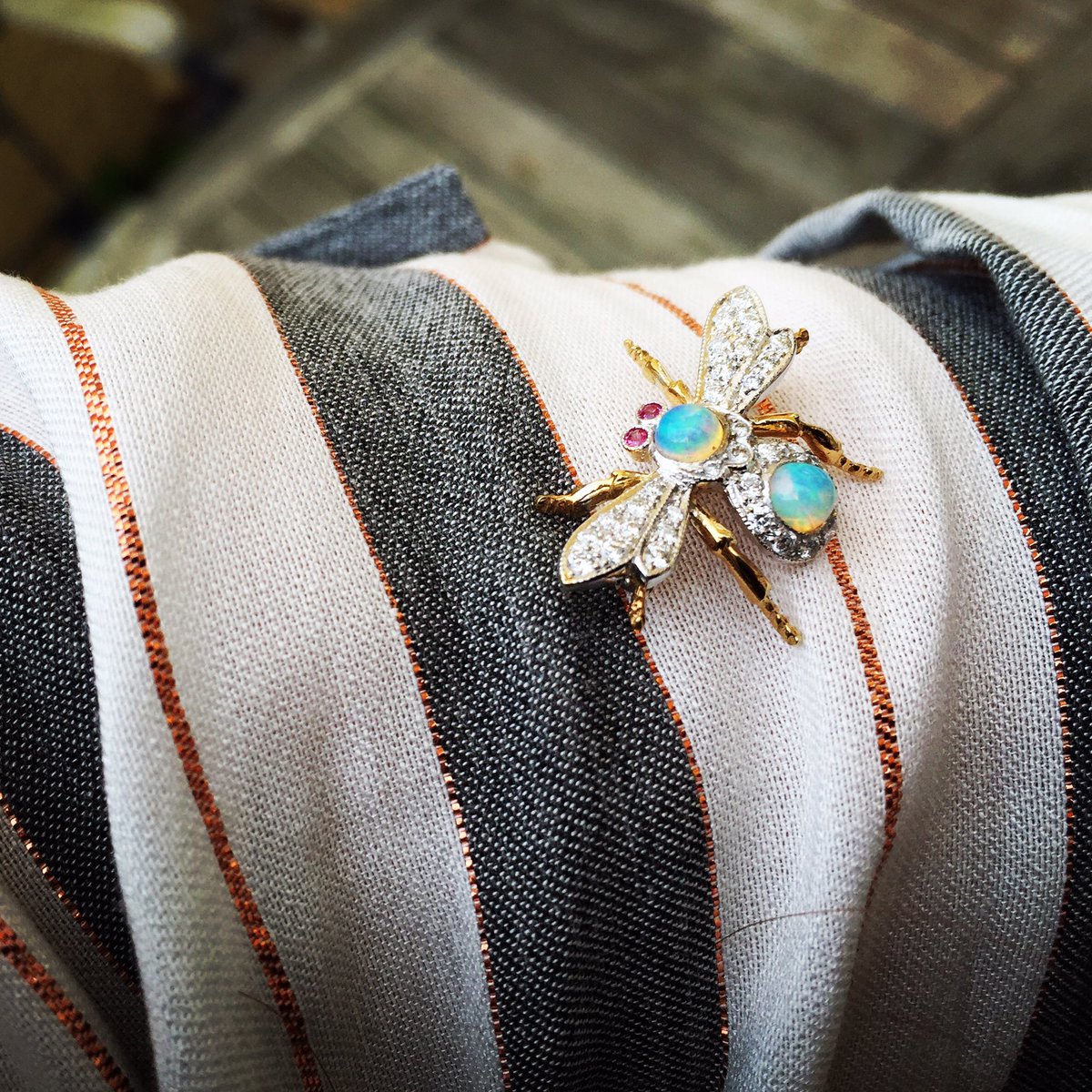WebbsJewellers's tweet photo. Opal, diamond and ruby bumble bee resting on my arm In the #heatwave of this #hottestdayoftheyear #hottestseptember https://t.co/dmY72sa1Al