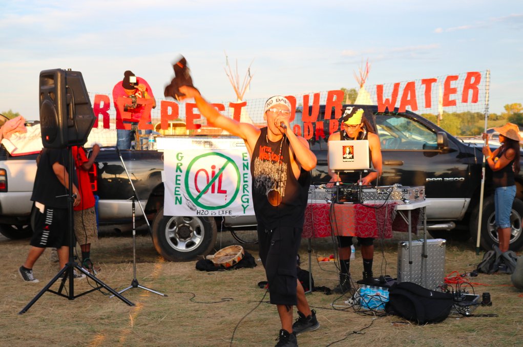 no_platform's tweet photo. "You can live without oil, but not water," says @ChiefThomasX at #NoDAPL hip hop show put on near #RedWarriorCamp https://t.co/4YU7hyEZUh