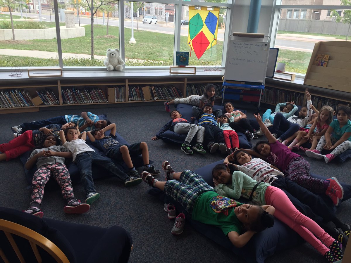 MsCardinali's tweet photo. Enjoying a story in the library. How will we all fit on the 4 big bean bags? #realproblemsolving #everydaymath https://t.co/xOpKT5kb4S
