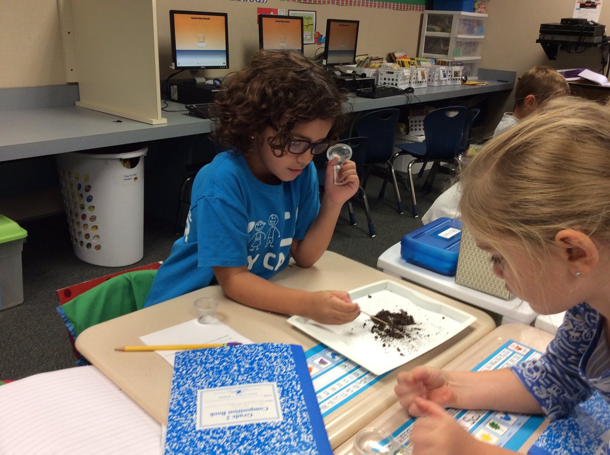 These scientists are hard at work observing their soil samples.