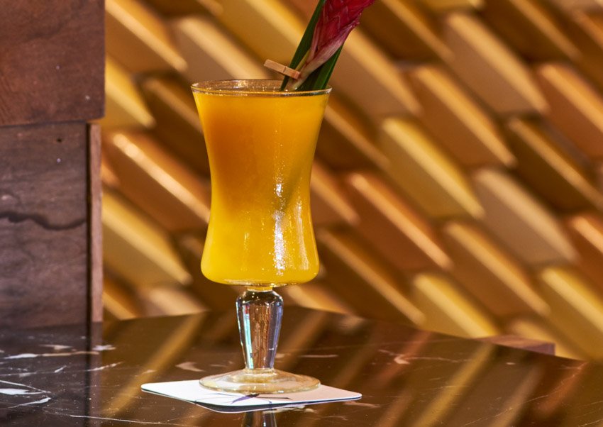 Pictured here is our "Bird is the word" cocktail made from Anejo rum, aperol, pandan and mango. She's stunning!