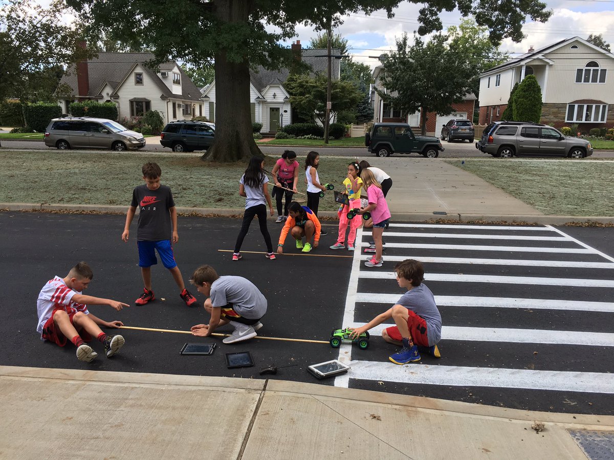 6th Graders testing force and motion by utilizing the smooth new bus lane!