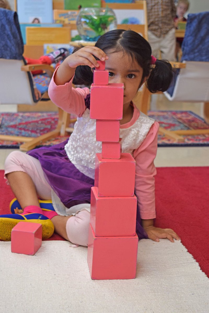 The wood cubes of the #pinktower allow children to develop coordination and understand dimension. #Montessori