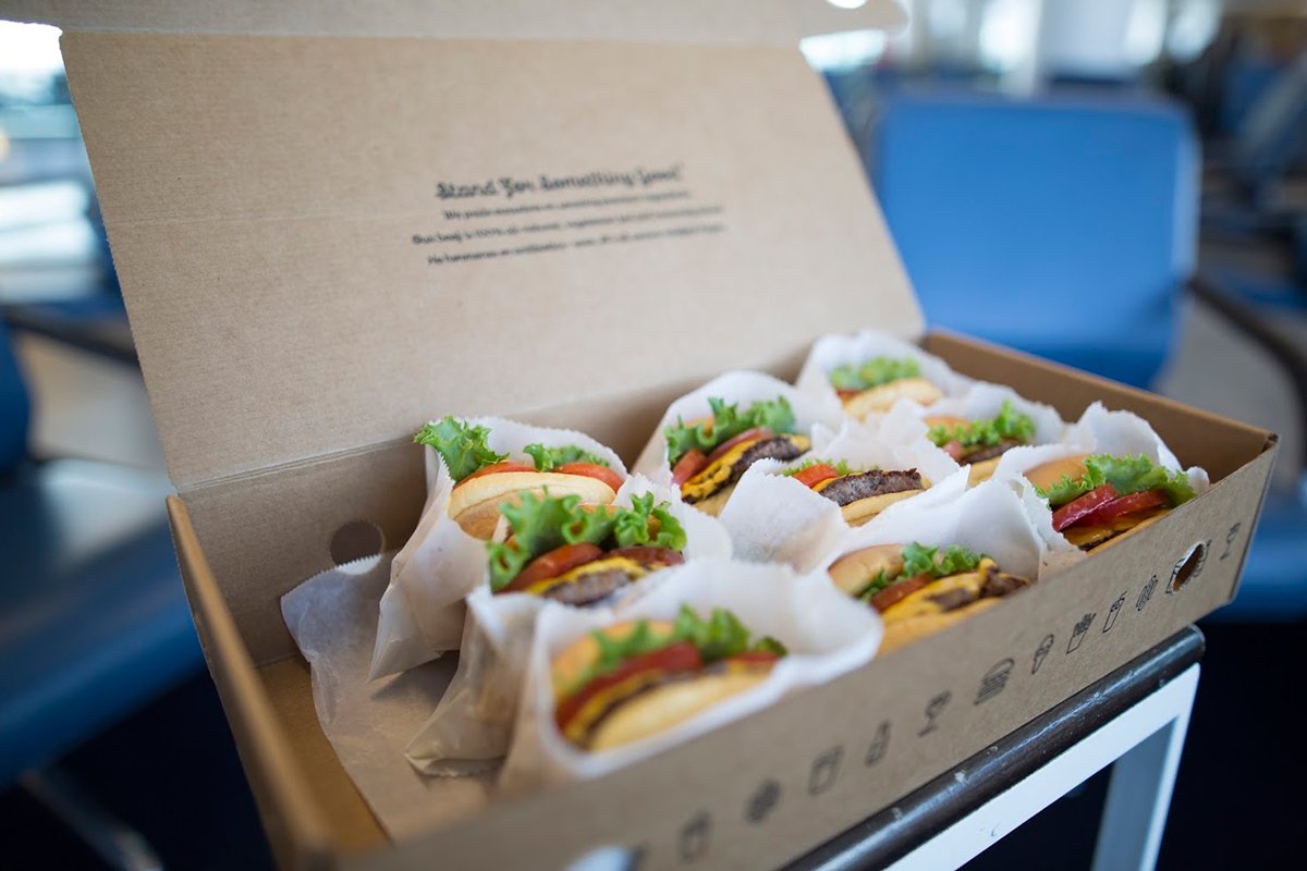 Delta's tweet photo. Flying from #JFK to #LAX today? You might be in for a surprise from @shakeshack. #NationalCheeseburgerDay https://t.co/LE22c2Ugj7