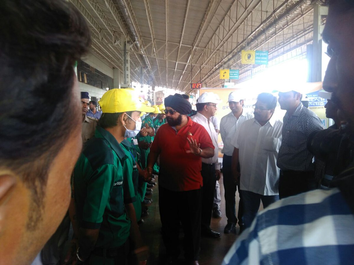TEAM OF CLEAN TRAIN STATION INTERACTING WITH SWR OFFICIALS