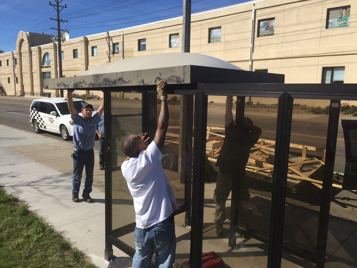 Placing the roof on one of the new shelters at the new transfer point on Front Ave.