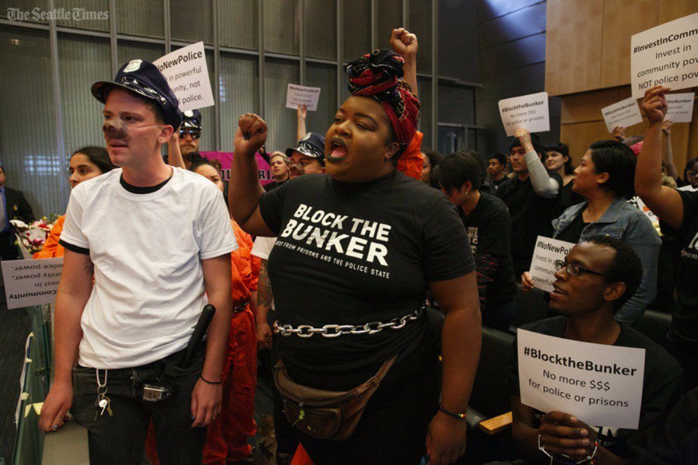 seattletimes's tweet photo. #BlockTheBunker foes of Seattle police station halt council meeting, expand demands: https://t.co/Y5MTT5mEPi https://t.co/oYrUIgpgkn