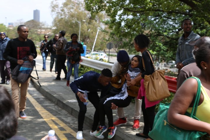 nzimandebafana's tweet photo. Wits student carried by others after police fired teargas and stun grenades at demonstrators. #Fees2017 #FeesMustFall #FeesMustFallReloaded https://t.co/tyNlt47xOc