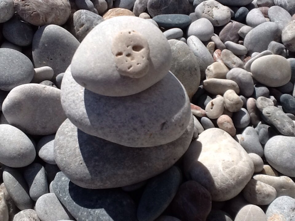 anniejay55's tweet photo. Is this an 'art installation' showing the ghosts of sunbathers before us.. Or just a load of old bol... pebbles on Haraki beach? https://t.co/4fvXRIbpym