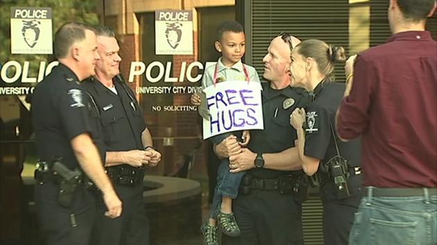 Kindergarten boy was scared during protests and gives cops in Charlotte 'free hugs' abc13