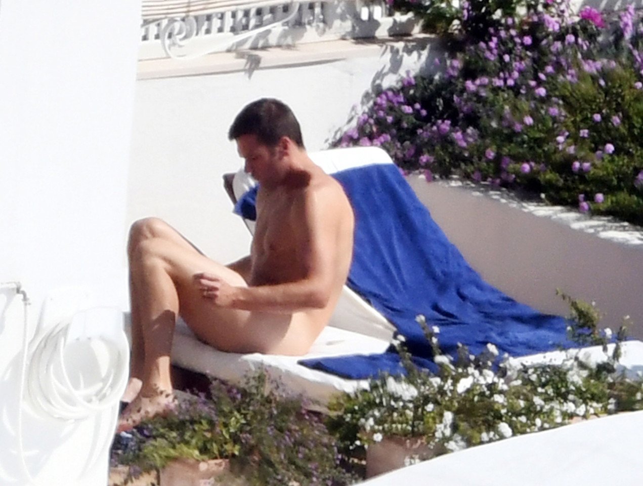 EXCLUSIVE: Naked Tom Brady sure seems to be enjoying his. 