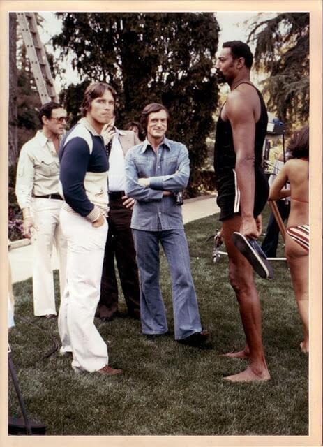Arnold Schwarzenegger, Hugh Hefner, and Wilt Chamberlain at the Playboy mansion in 1977.