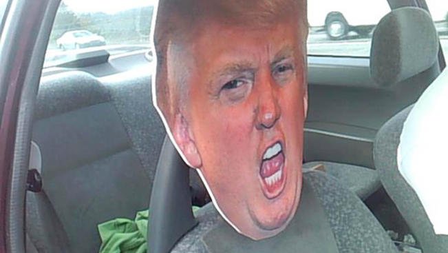State trooper notices driver trying to sneak down carpool lane with huge Donald Trump head