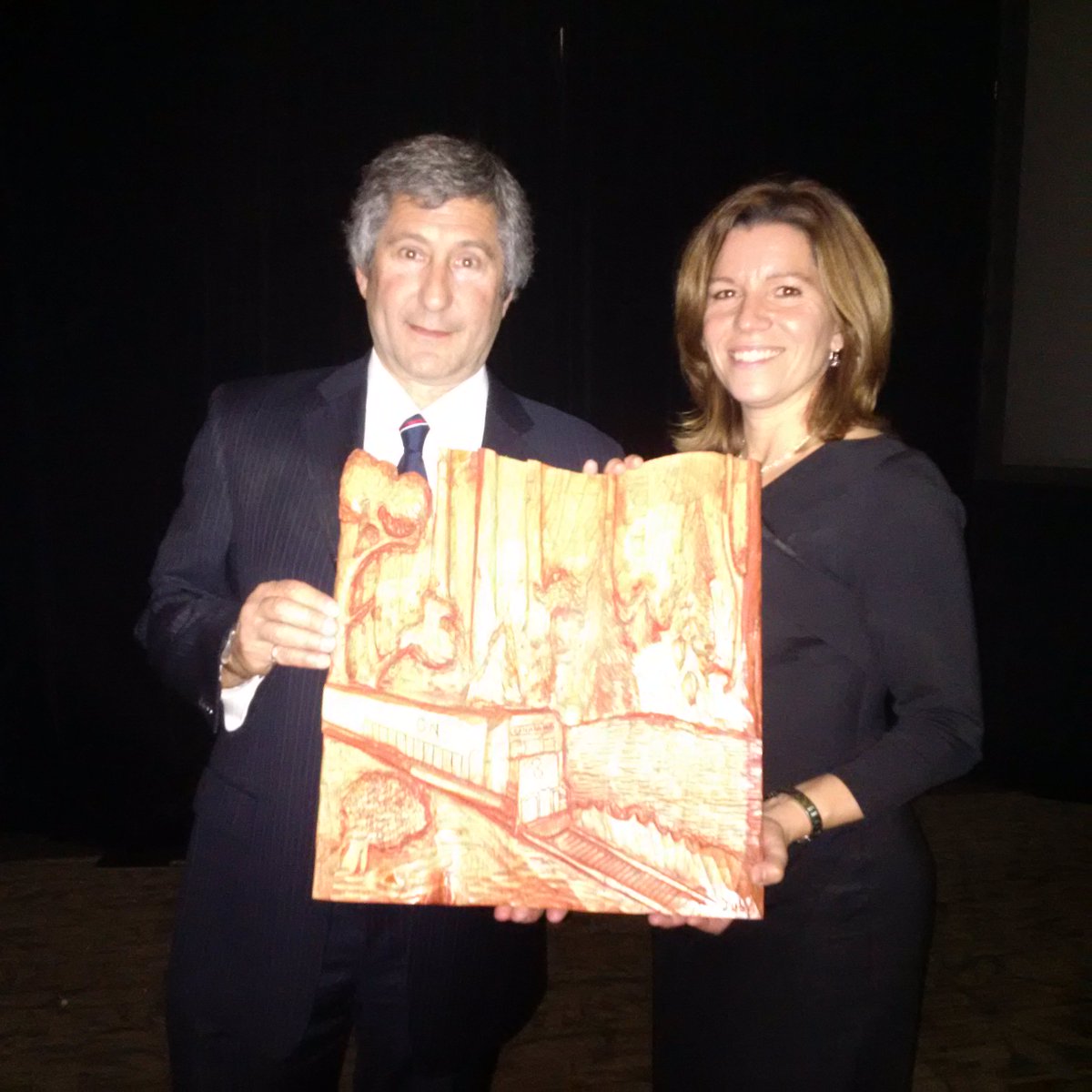 TreeCanada's tweet photo. Michael Rosen presenting recognition carving to Nuria Pérez de León of CN for planting 1.2 million trees with Tree Canada #CUFC2016 https://t.co/d3M9QftcQT