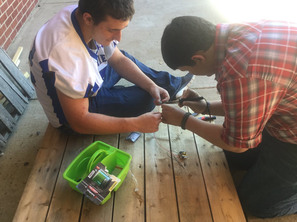 Colby &amp; Jacob busy soldering for their project. With Ex-Charge, you can charge your cell phone while you ride your bike! ;)