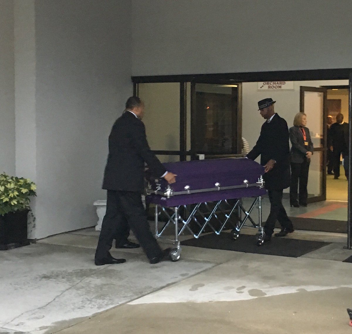 Small purple and white caskets escorted into church, carrying the 4 and 6 year old sisters killed by their father.