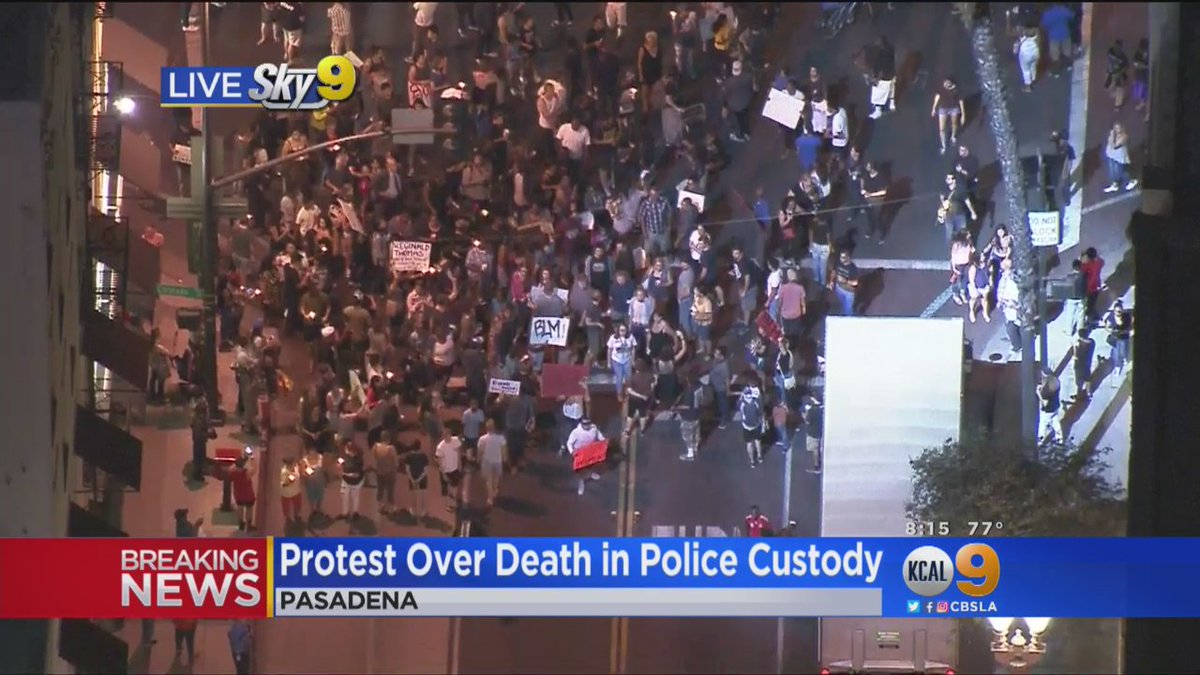 Protesters march in Pasadena after man's death in police custody earlier Friday.