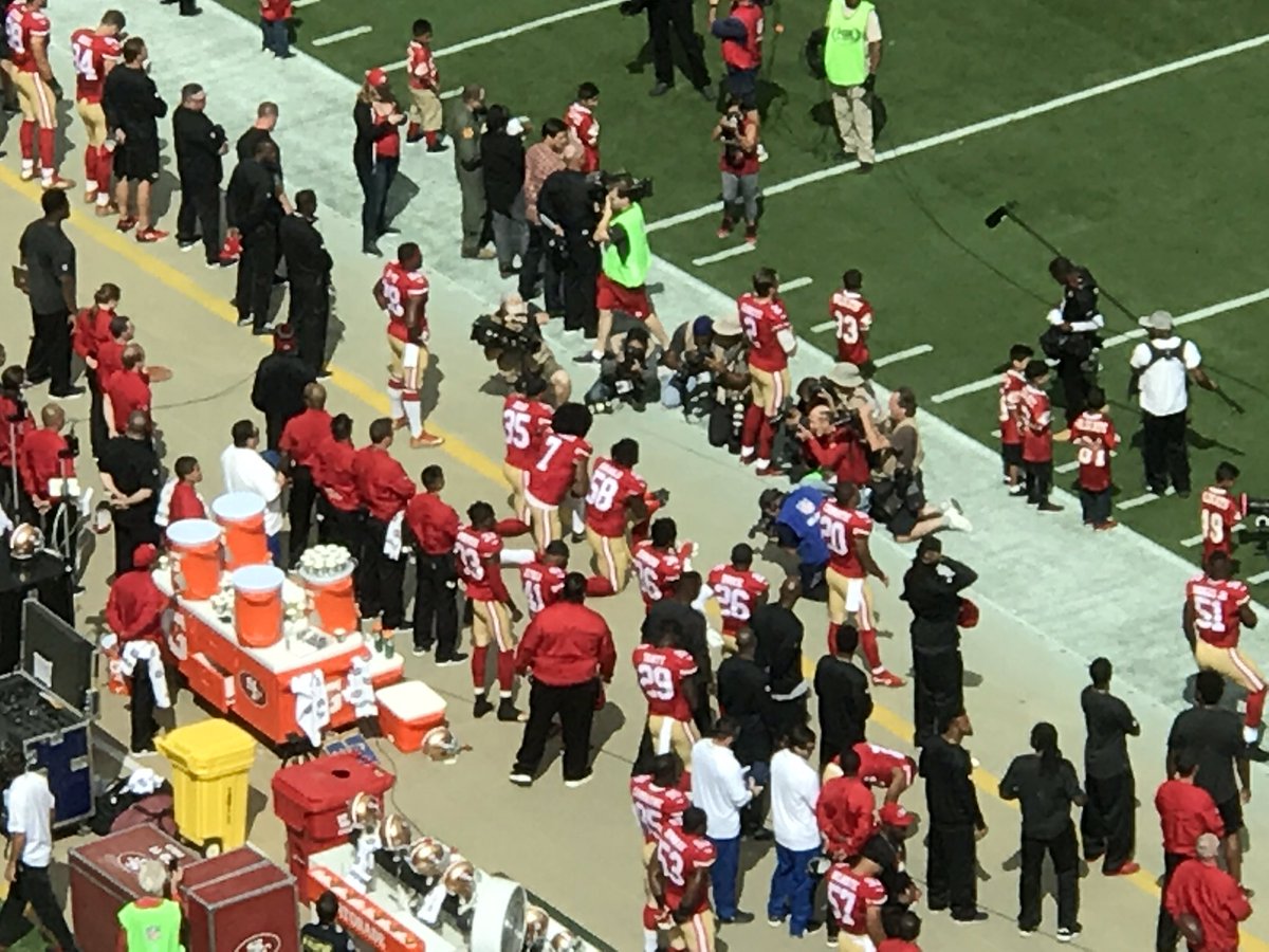 JoeTrahan's tweet photo. All #Cowboys standing while Colin Kaepernick and 2 teammates kneel during the anthem.
#DALvsSF
#WFAACowboys https://t.co/XUjzgyI8mR