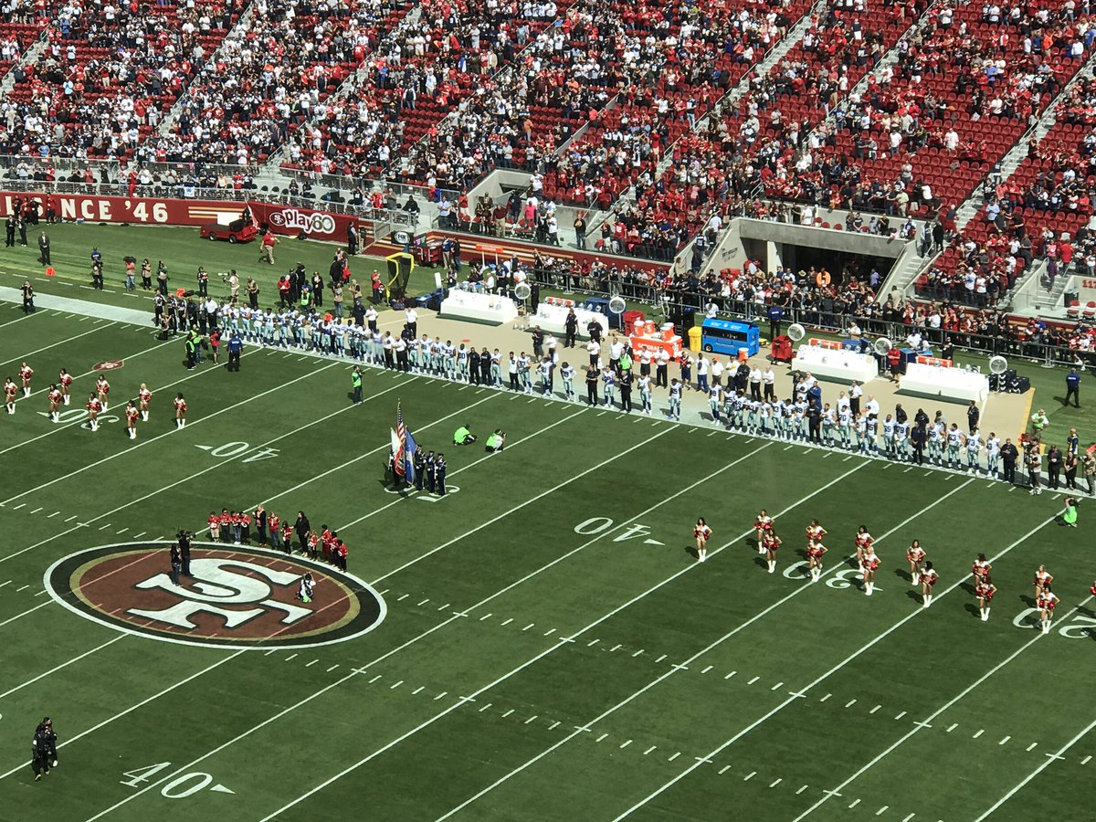 JoeTrahan's tweet photo. All #Cowboys standing while Colin Kaepernick and 2 teammates kneel during the anthem.
#DALvsSF
#WFAACowboys https://t.co/XUjzgyI8mR