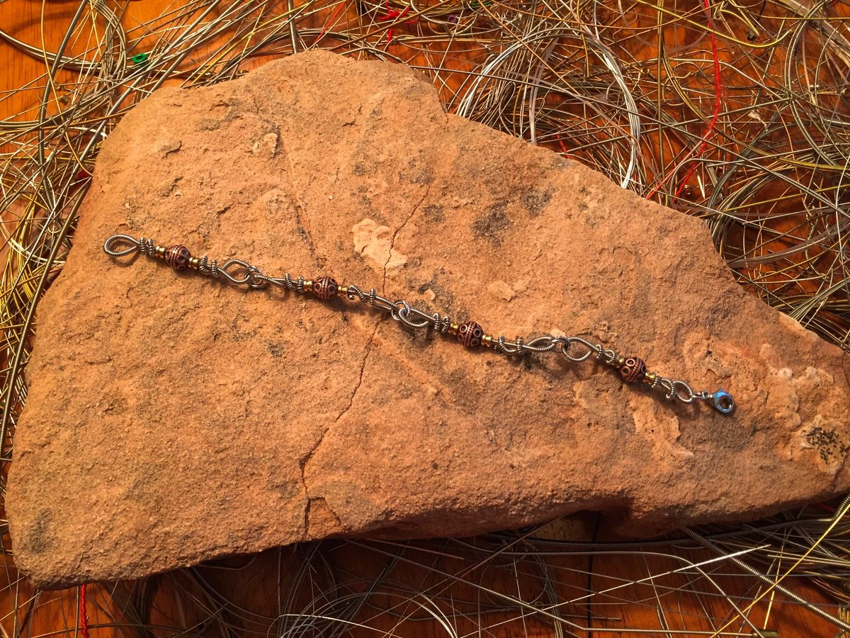 RetunedJewelry's tweet photo. So, what do you think of our new bracelet design? #jewelry #handmade #etsy #guitar #guitarstrings #guitarstringjewelry #bracelt https://t.co/TCCl75pUHa