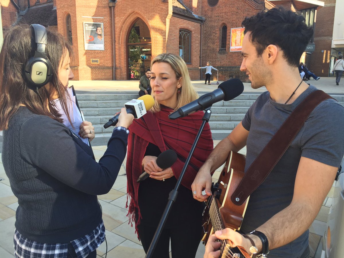 BBCSurrey's tweet photo. Singing live in Jubilee Square #Woking, Richard and Calli "Cardboard Carousel" for our #BBCBus tour https://t.co/PXxfDPgrjT