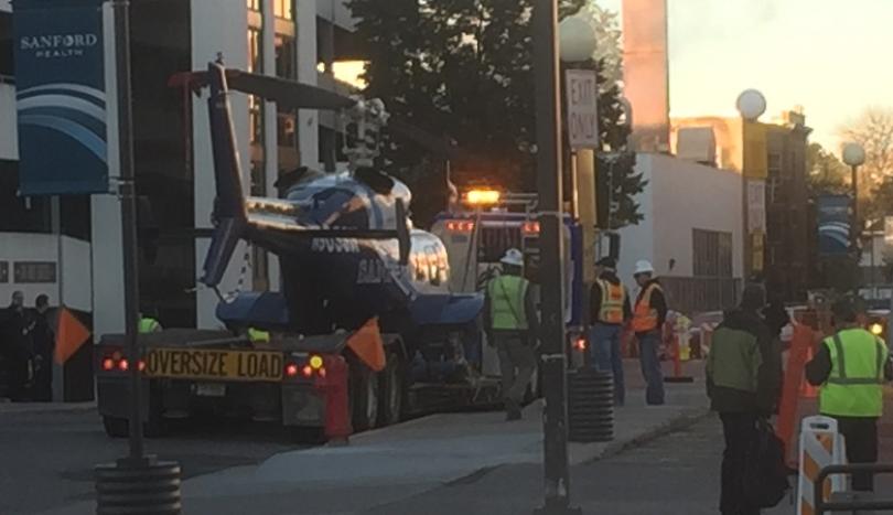 ValleyNewsLive's tweet image. Damage to tail leaves helicopter stuck on top of Sanford Hospital. Crane used to get it down. valleynewslive.com/content/news/M… #VNL