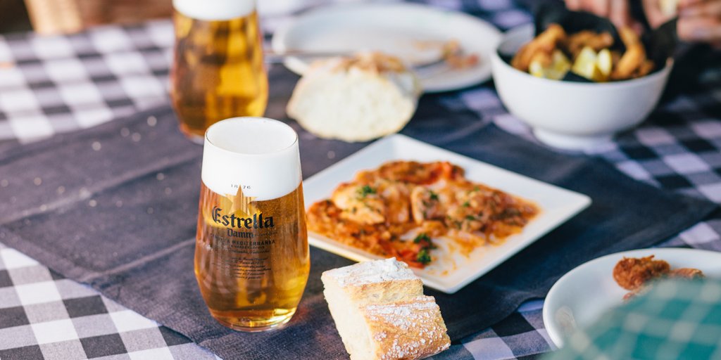 Break bread tonight over fresh seafood tapas, served with some Estrella Damm.