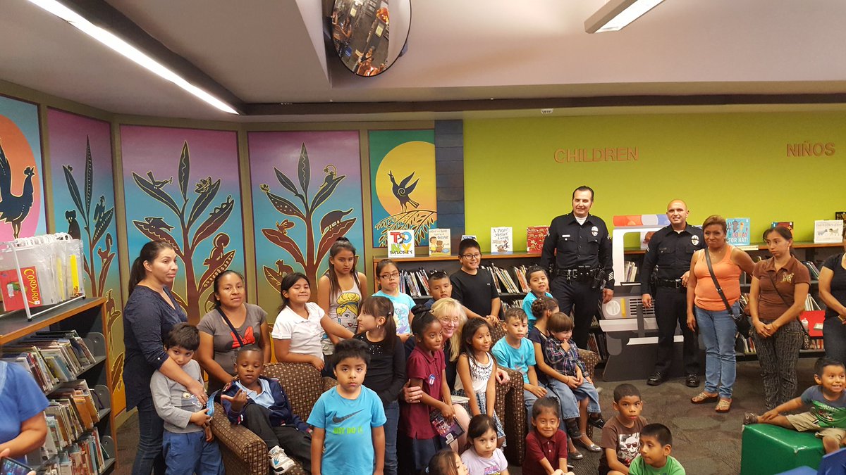 LAPDHQ's tweet photo. Our day continued w/ @USAttyDecker bringing smiles to kids @ our @LAPublicLibrary &amp; #LAPD  #readalong @ Vernon Branch Library in @NewtonLAPD https://t.co/eKcTXc5uiW