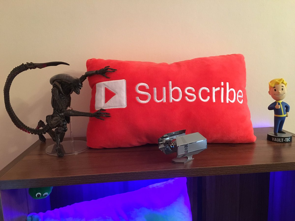 Sethum83's tweet photo. Check out my new prop! I got an Alien Dog Action figure for my shelf and he seems to like my #Subscribe cushion. What do you think of it? https://t.co/t1cL2zVxUQ
