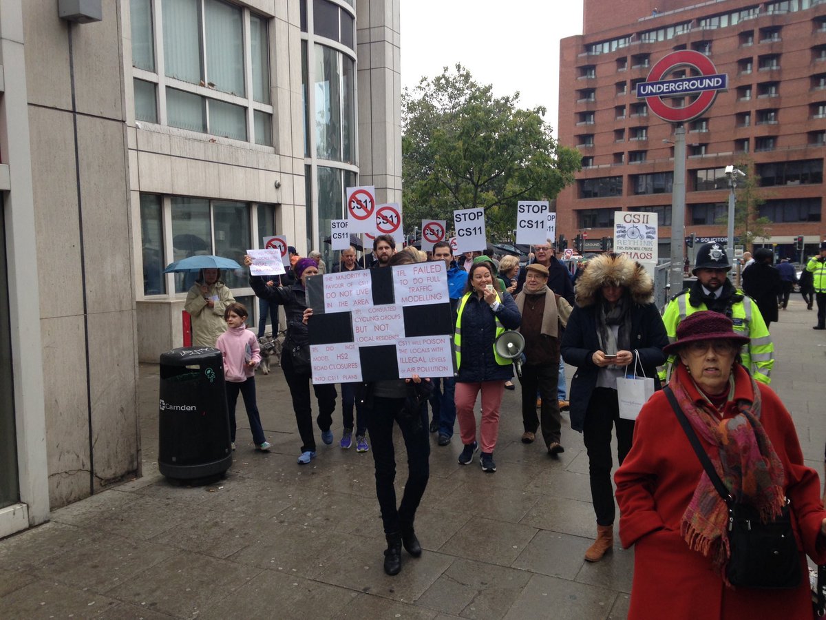 PidginPosting's tweet photo. If you look very closely at this photo you see this protest has the essential element of an embarrassed looking dog. #savecs11 https://t.co/tDvIEu8LYi