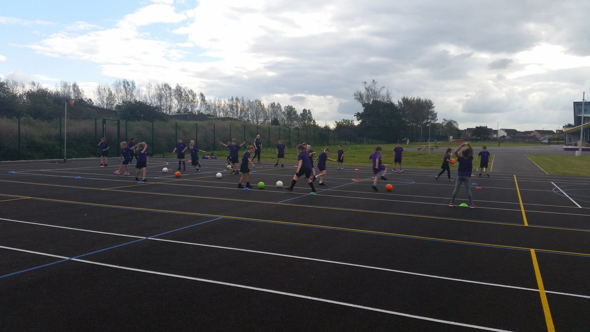 Year 4 children enjoying football drills with Hayley 5/60 officer