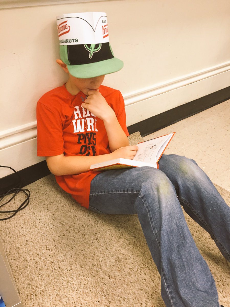 You know you're a reader when...even a Krispy Kreme birthday celebration can't peel you away from a good book. #tatemtigerpride #candidshot