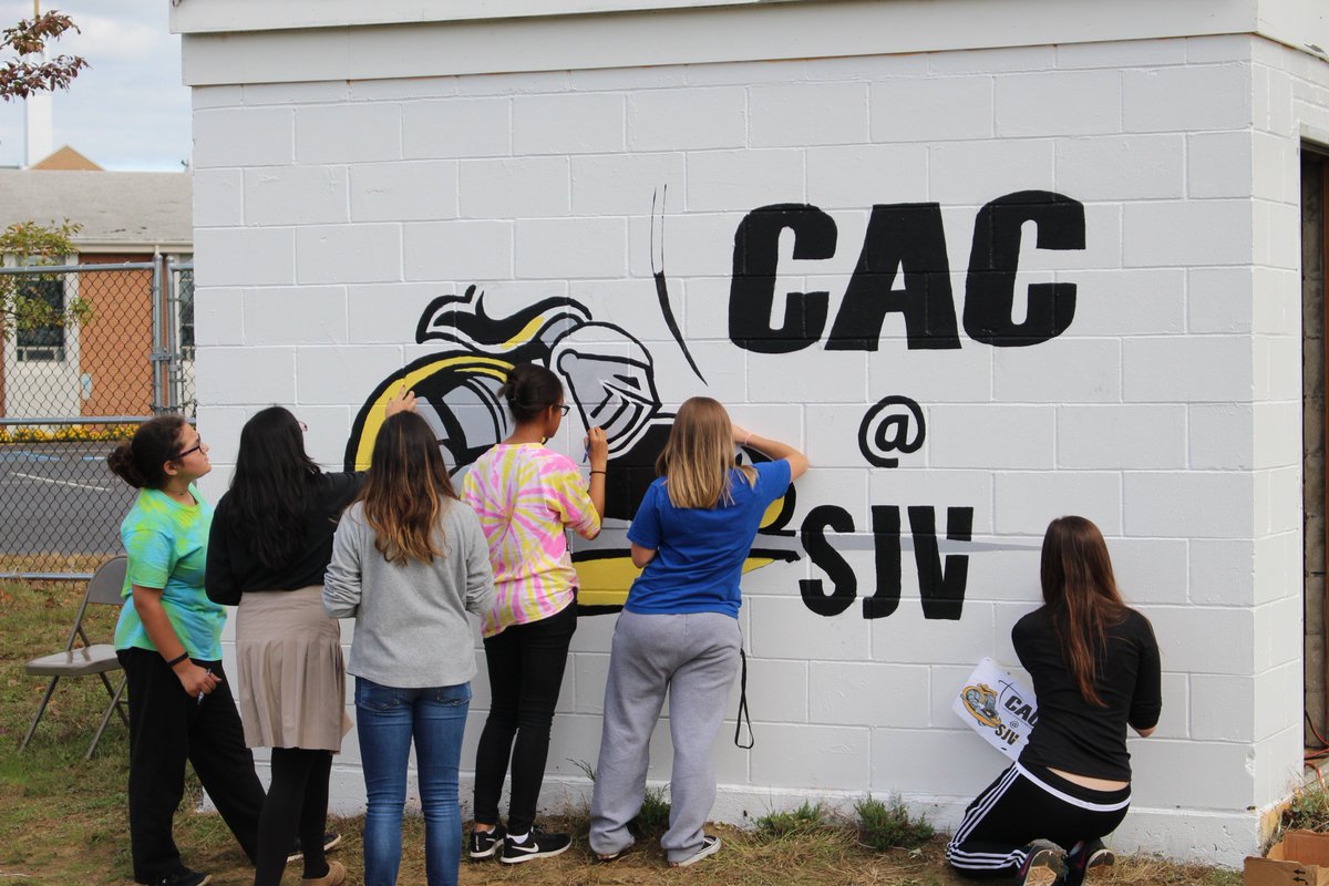 SJVHS's tweet photo. SJVHS Art Club paints Catholic Athletes for Christ (CAC) logo near turf field. @CatholicAthlete @SJVSA #sjvlancers #sjvartistsofthefuture https://t.co/djZTFtVS17