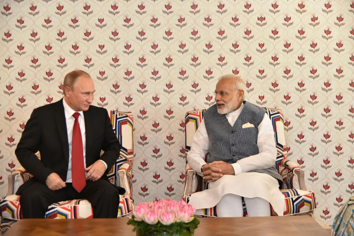 MEAIndia's tweet photo. A quiet tete-a-tete before beginning restricted talks. PM @narendramodi and President Putin @KremlinRussia_E meet in the Leaders Lounge https://t.co/9uyh76u39M