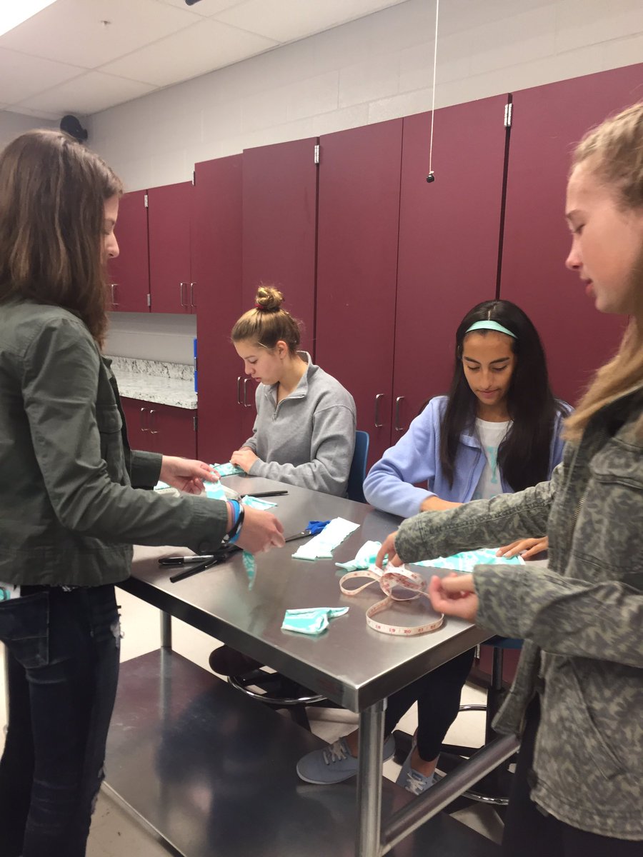 Interact members creating head wraps for young cancer patients this morning. #makingadifference