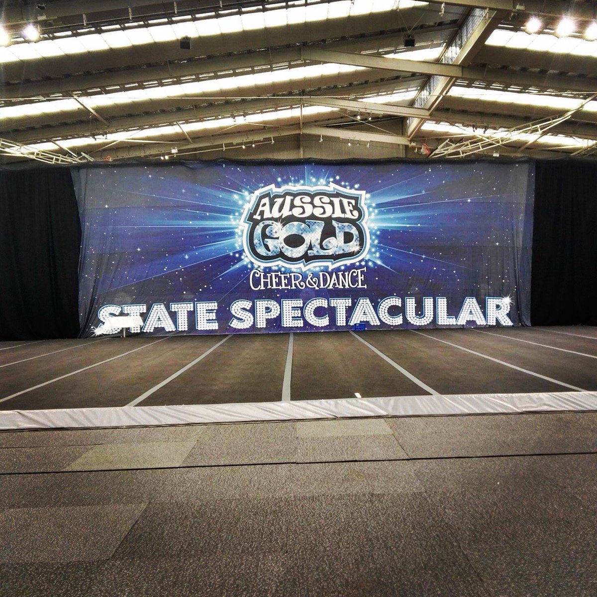 aussiegold_'s tweet photo. Comp floor all set up! Loving the new State Spectacular Banner! Can't wait to see everyone perform in front of it. Comp kicks off in 1 hour! https://t.co/YAJWMNNO0W