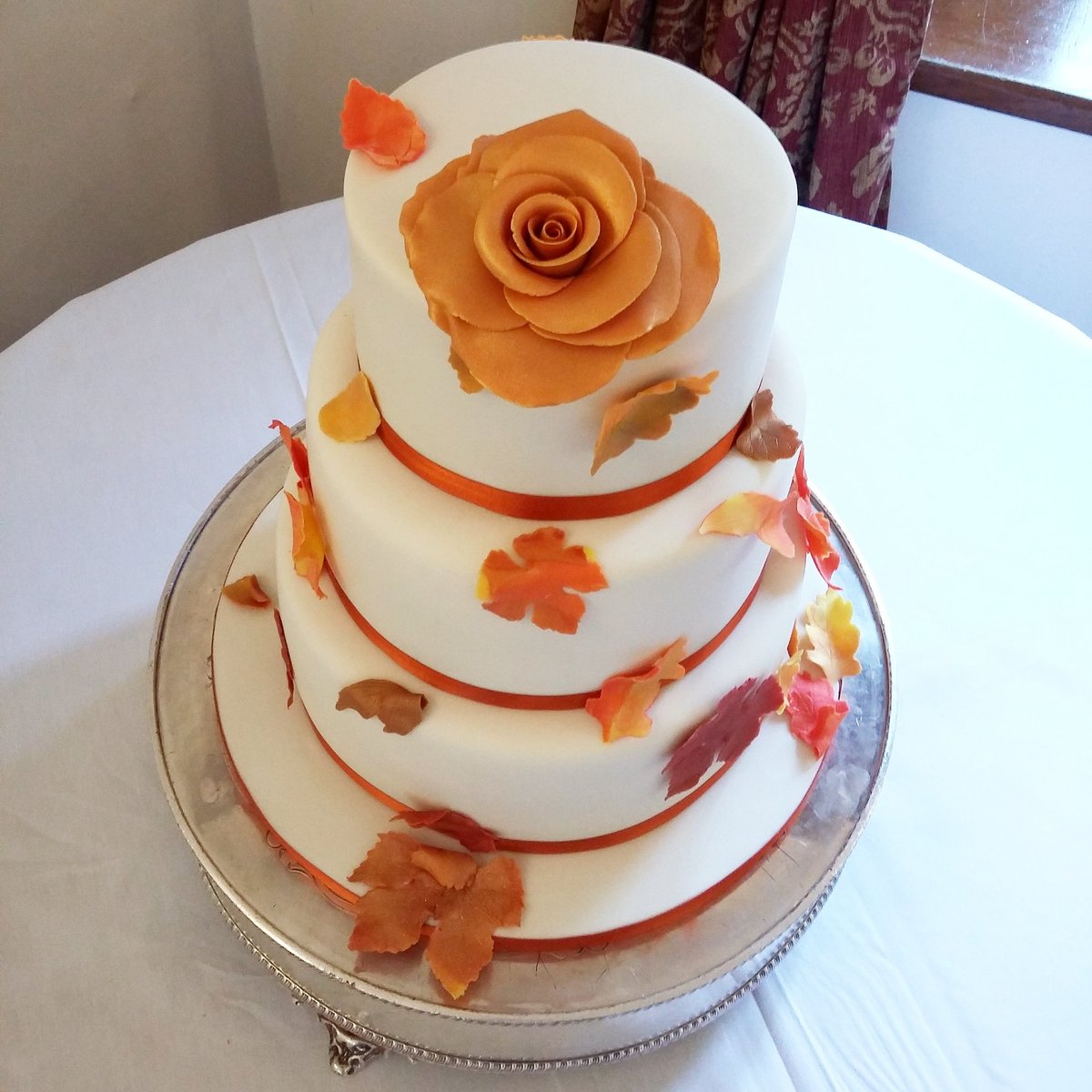 An autumnal themed wedding cake with crisp russet &amp; golden leaves and a beautiful golden orange rose at the stunning <a href="/BoringdonHall/">Boringdon Hall</a> Hotel