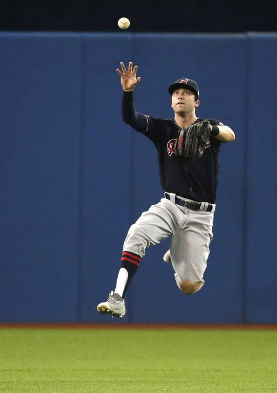 PostmediaPhoto's tweet photo. #Indians' Tyler Naquin leaps to catch a #BlueJays' Ezequiel Carrera hit during #Game4 @Craigerphotos @BlueJays https://t.co/lIhtb2amuH