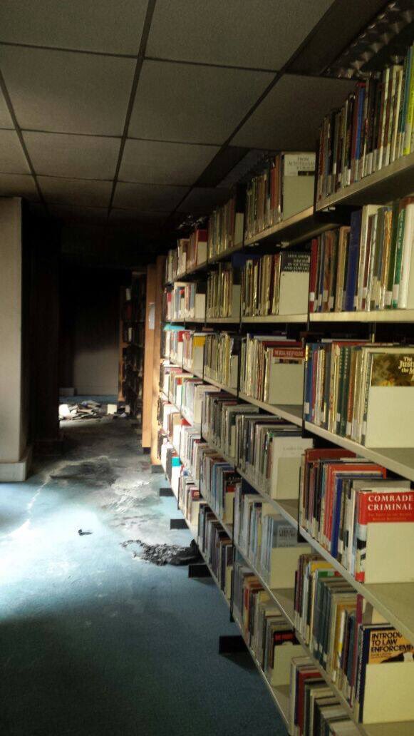 Renegade_Report's tweet image. The library at Wits was burned last night. 

The unburnt, red book is called &apos;Comrade Criminal&apos;.