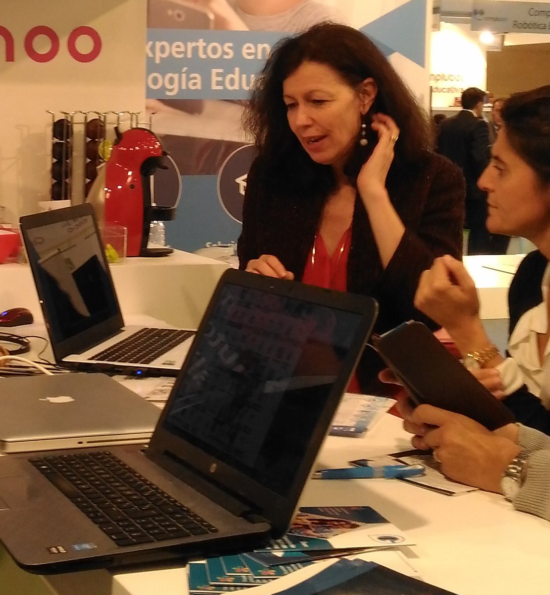 easy_prof's tweet photo. Our CEO, Marie-Christine Jené, with future clients. Showing them the powerrful functionalities of #EasyProf. At @SIMOEDU_ and @feriademadrid https://t.co/ANM26fbtOU
