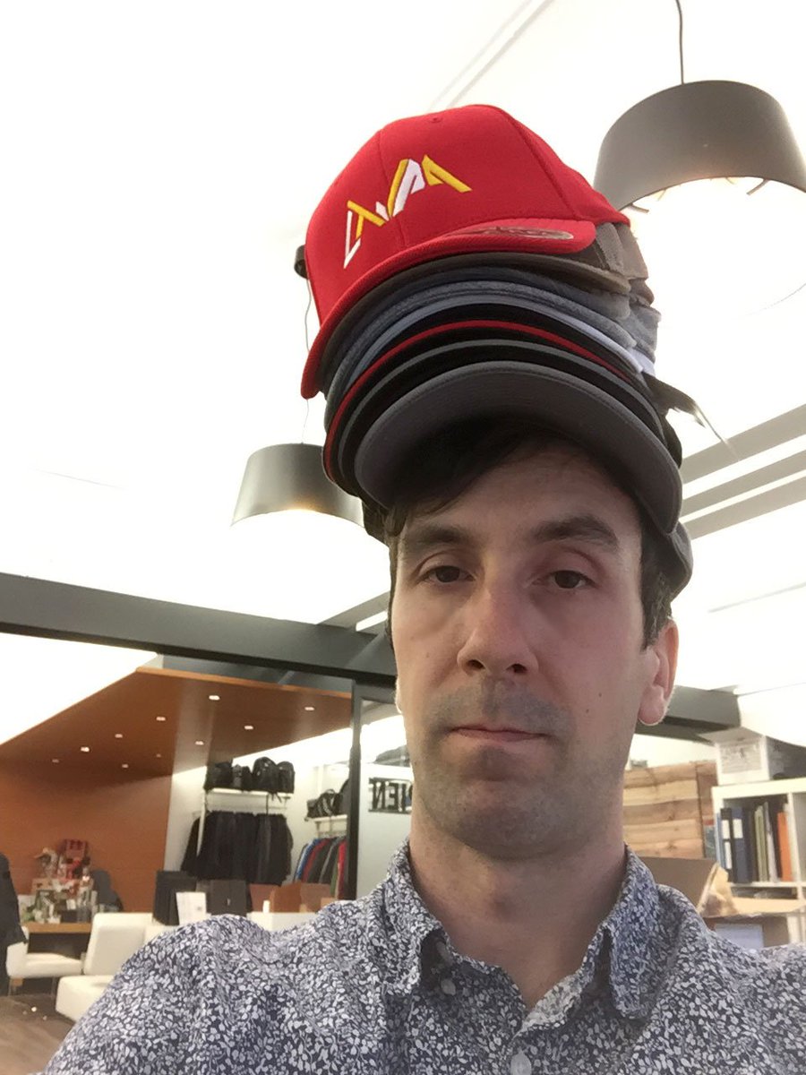 promo_sapien's tweet photo. New hat day in the office. Can you beat this record breaking stack by Ben? #promotionalproducts #daringstunts https://t.co/AzUId17ROa
