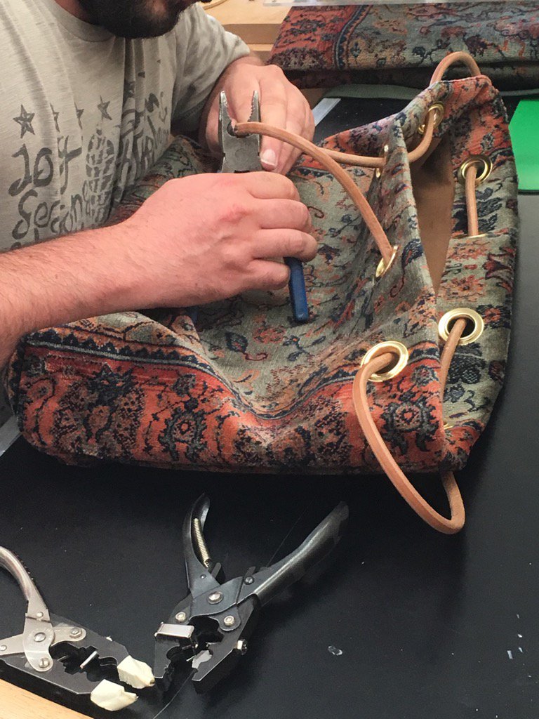 carpet_bags's tweet photo. Giving the final expert touches on a #Cosmicbag in #Verda fabric! #carpetbag #handcrafted #madeinBritian #Artisan https://t.co/og2BRFarPw