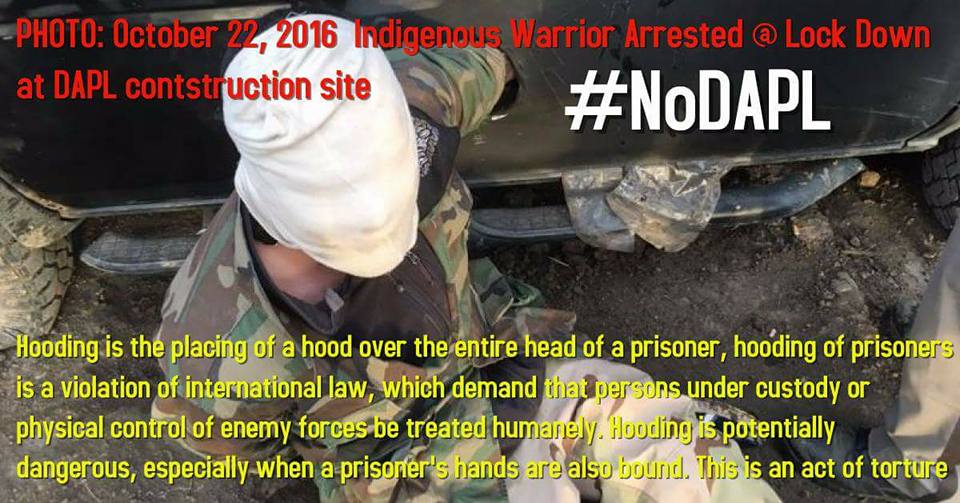 savage_science's tweet photo. PHOTO from Morton Co Sheriff FB page 10-22-16: Water protector arrested, hooded @ #NoDAPL construction site.This is an act of torture. @ACLU https://t.co/MzjYKXnbDo